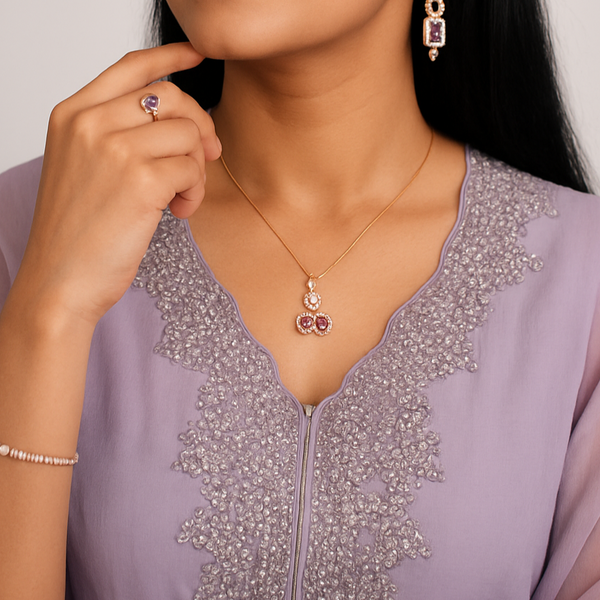 Woman wearing jewelry including earrings, necklace, and ring, with a plain background